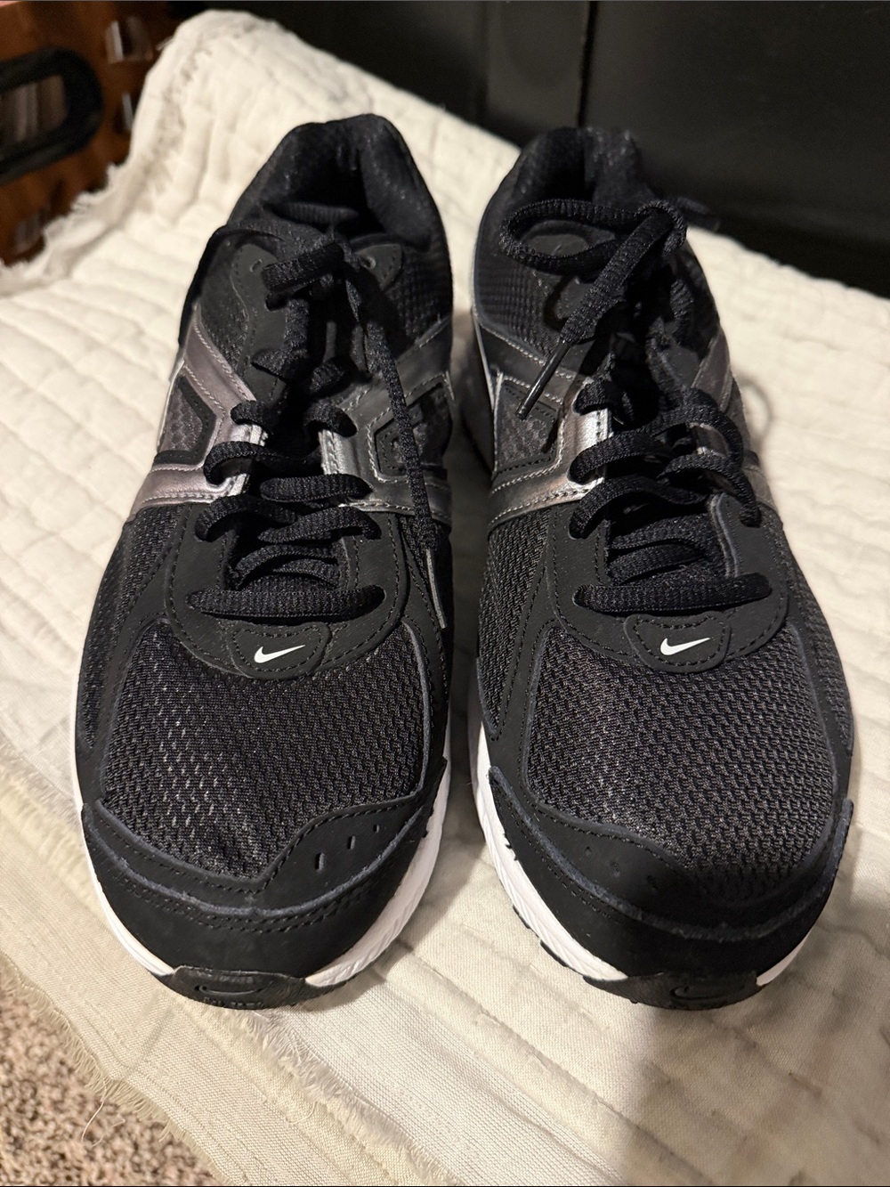Women’s Size 8 Nike Black and White Mesh Running Sneakers with Silver Accents.